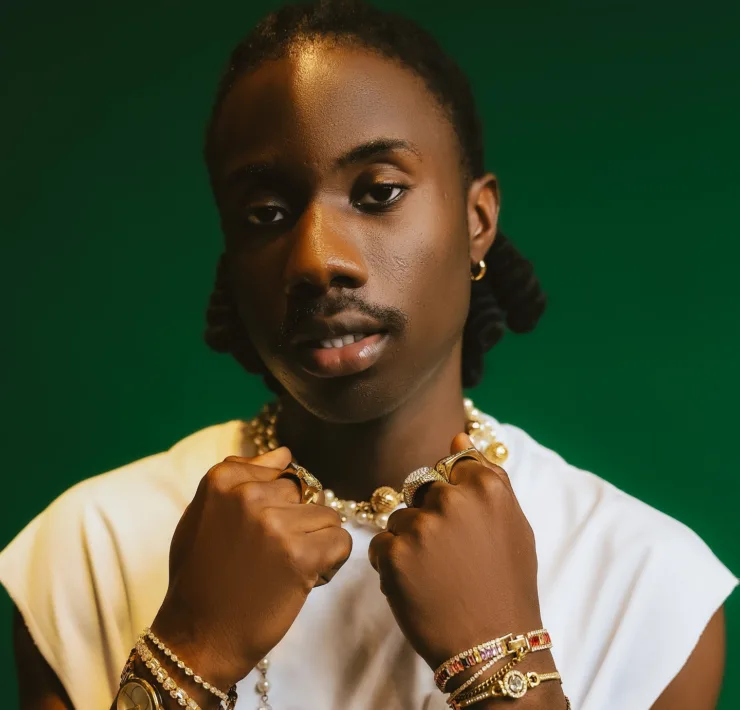 Oluokun Temitope Tariq, known professionally as TAR1Q, is redefining African music with a unique, genre-blending style that has quickly caught the industry’s attention. Signed to Chocolate City Music and known for his velvety voice, TAR1Q seamlessly melds Afrobeats, Pop, Hip-Hop, and R&B into a sound that feels both innovative and deeply personal. His music isn’t just about catchy melodies; it’s a form of introspective storytelling, capturing both the past and present of African experiences in a way that resonates with listeners worldwide. Born on May 1st in Benin City, Nigeria, TAR1Q grew up in a family where cultural diversity and self-expression were part of everyday life. His journey into music began at 12, and after a move from Delta State to Lagos, he found himself drawn to songwriting as a way to make sense of his experiences. What started as a hobby soon turned into a passion as he began crafting narratives that felt like conversations, bringing an introspective depth and vulnerability to his lyrics. In 2022, TAR1Q released his debut EP, Son of the Moon, introducing fans to his honest and evocative storytelling. This project, which included tracks like “sIgNaLs,” “bAd IntentIons,” and “bE MInE” featuring Blaqbonez and Ria Sean, gave listeners a glimpse into his creative journey and themes of love, self-discovery, and growth. The success of “bAd IntentIons” propelled him further into the limelight, establishing TAR1Q as a fresh, authentic voice in the Nigerian music scene. TAR1Q’s sound continued to evolve in 2023 with the release of his second EP, All I Felt, featuring fan favorites like “PrEttY Like” and “iN My FeeLinGs.” Now, in 2024, he has captivated audiences with his most recent project, Okada Airlines, currently being promoted across platforms. This eight-track EP includes collaborations with notable artists, such as Young Jonn on “Bus Stop (Remix)” and Khaid on “Jigga,” showcasing his artistic growth and musical versatility. Beyond his solo projects, TAR1Q has contributed to collaborations that further highlight his versatility, including “Santa Monica” by Dumoni the Jig and “Dealer” by 10Ten. His collaborations reflect his appreciation for the diversity within African music and his desire to continuously push boundaries. With Okada Airlines as his latest milestone, TAR1Q has positioned himself as a promising artist who challenges norms and brings a fresh perspective to African music. His journey is one of passion, authenticity, and artistic exploration, inspiring fans to embrace their individuality and live truthfully. As he builds his legacy, TAR1Q continues to captivate audiences, setting a new standard for what African music can be.