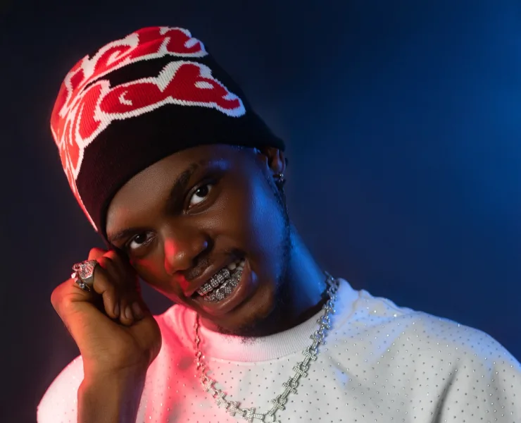 a man with braces wearing a beanie and a necklace Mikon Asuquo